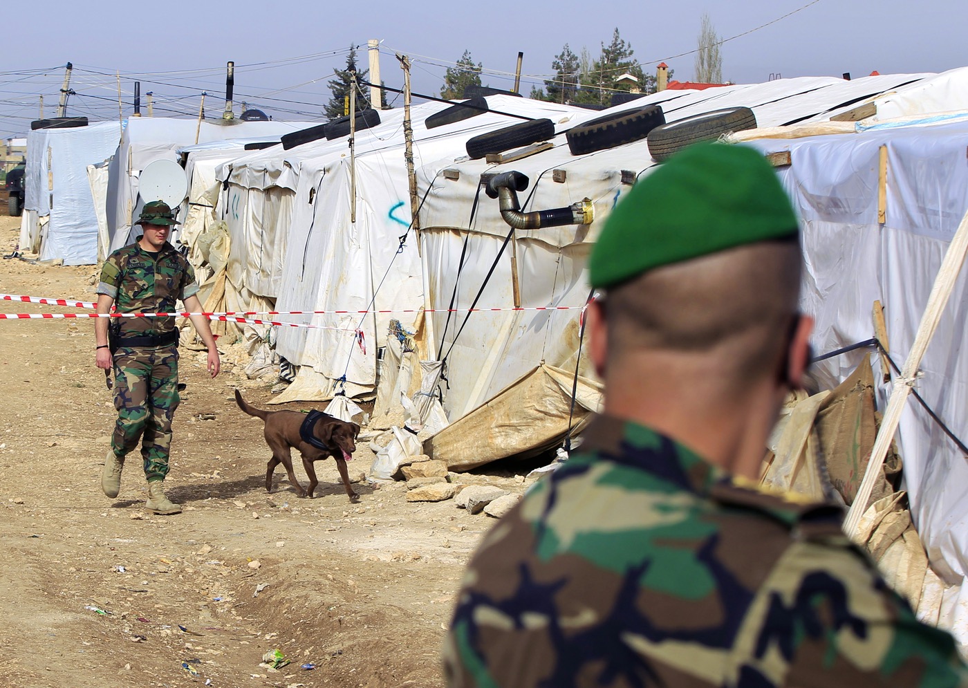 Lebanese soldiers in a refugee camp in the Syrian town of al-Dalhamiyya in the Beqaa before a visit by a senior official (AP)