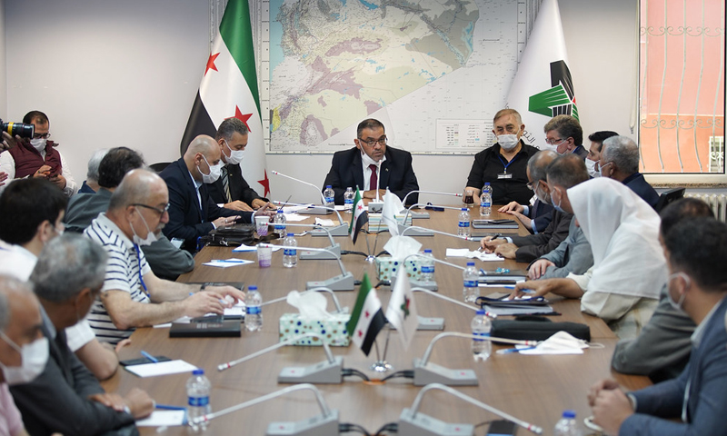 Anas Abdah, the former president of the Syrian National Coalition in a meeting with coalition members (The official website of the Syrian National Coalition)