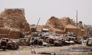 A car dumpster in front of the ancient al-Raqqa's Wall, which was bombed by the International Coalition Forces (ICF) in 2017 - November 2020 (Enab Baladi / Hussam al-Omar)